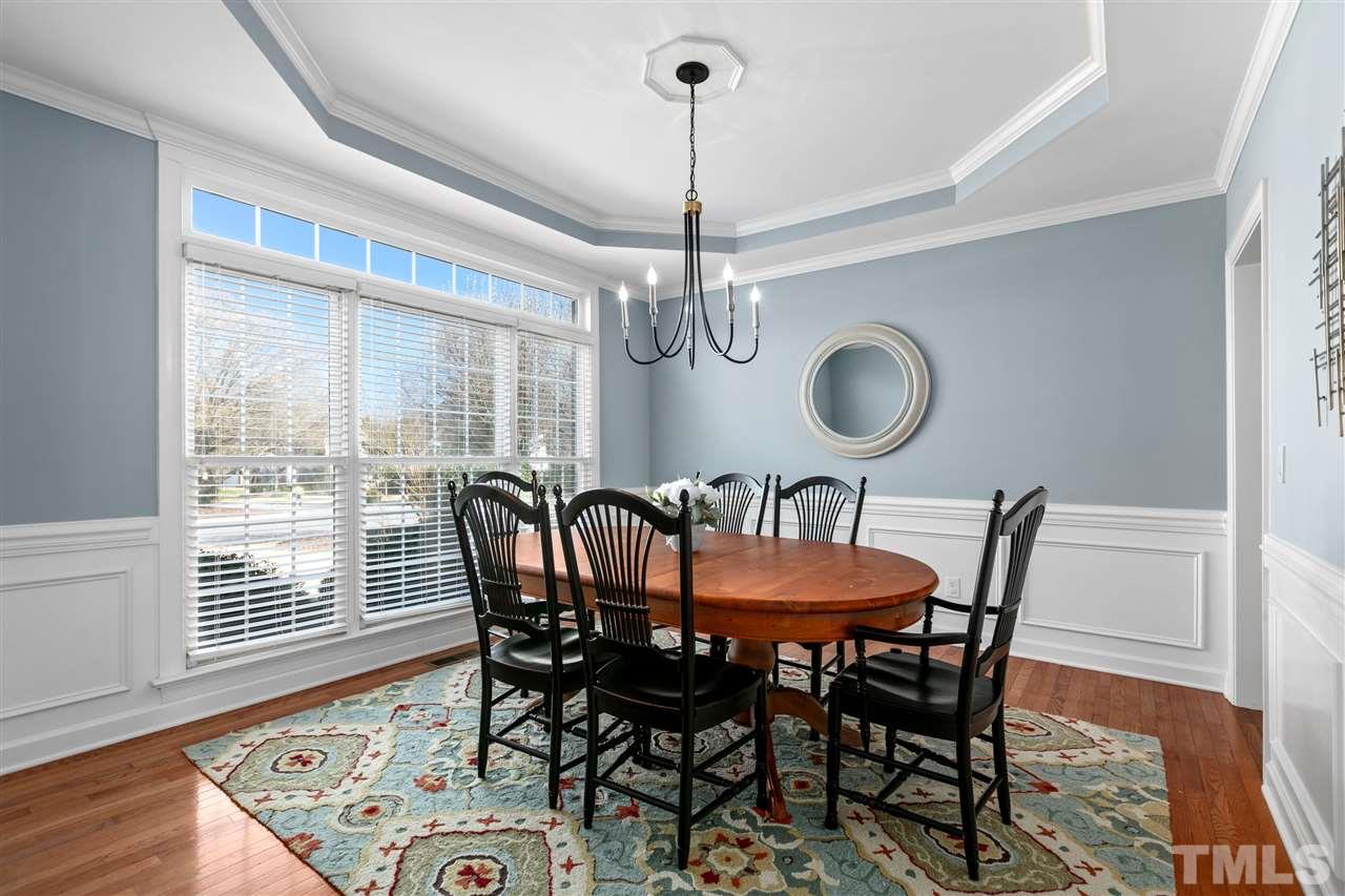 106 Ecklin Lane Cary, NC 27519 - Photo 4 of 29 a dining room with furniture a chandelier and wooden floor