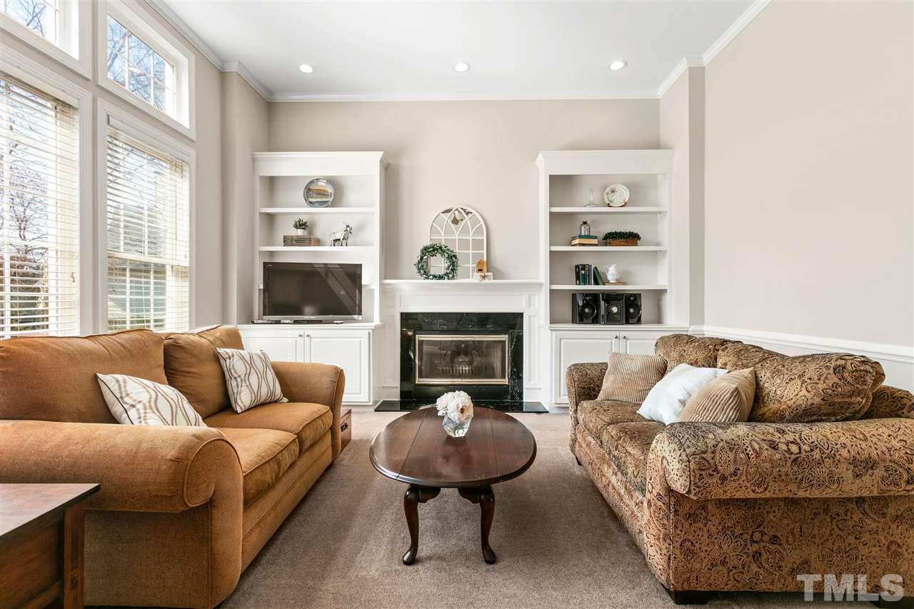 106 Ecklin Lane Cary, NC 27519 - Photo 6 of 29 a living room with furniture a fireplace and a large window