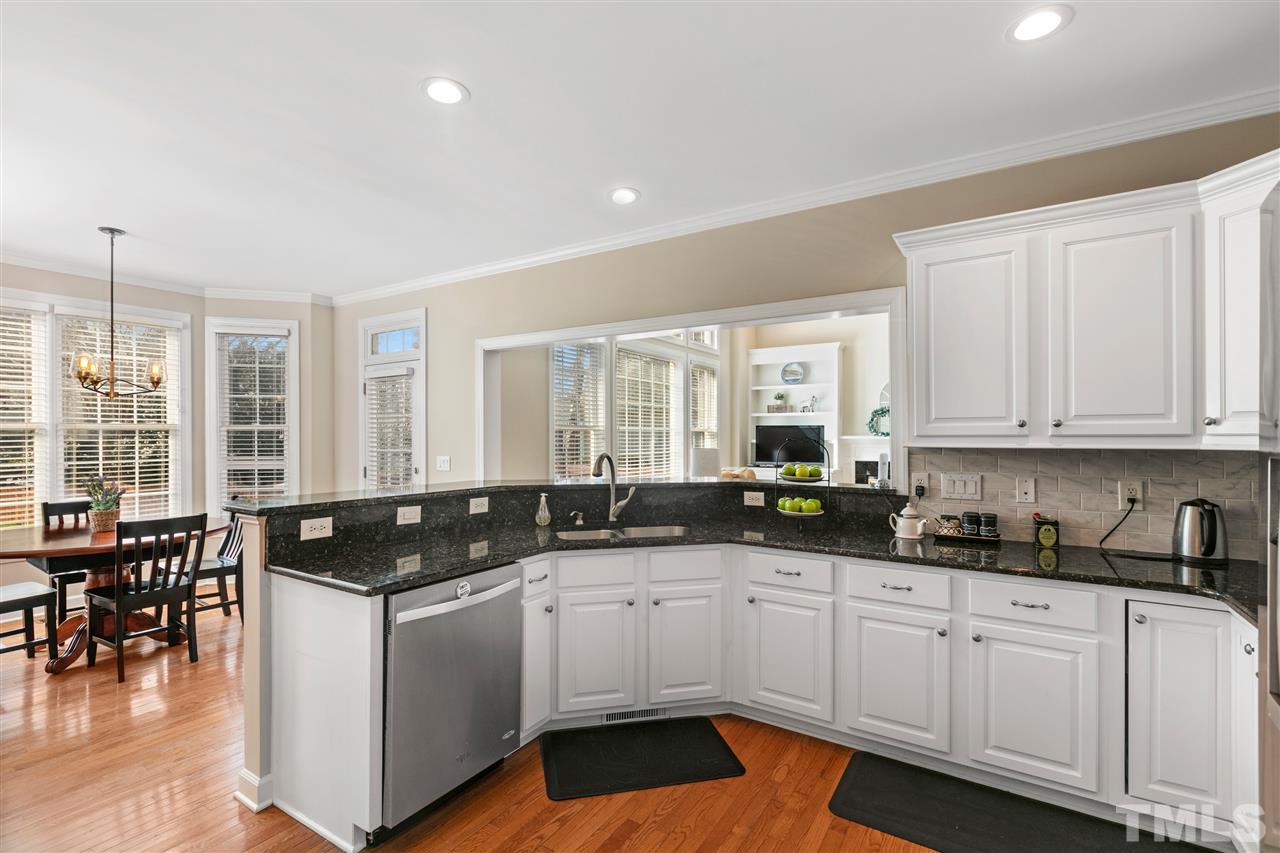 106 Ecklin Lane Cary, NC 27519 - Photo 8 of 29 a kitchen with granite countertop a sink and white cabinets