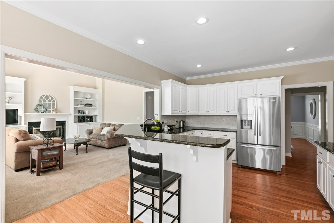 106 Ecklin Lane Cary, NC 27519 - Photo 10 of 29 a kitchen with a refrigerator and a stove top oven