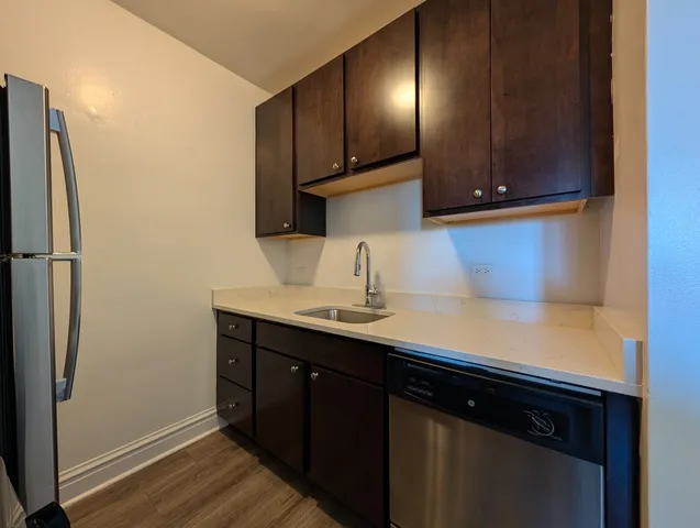 a kitchen with a sink cabinets and stainless steel appliances
