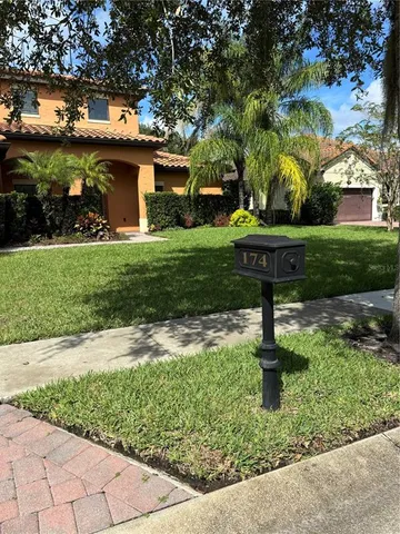 a view of a backyard with plants and a garden