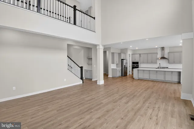 a view of a kitchen with wooden floor and electronic appliances