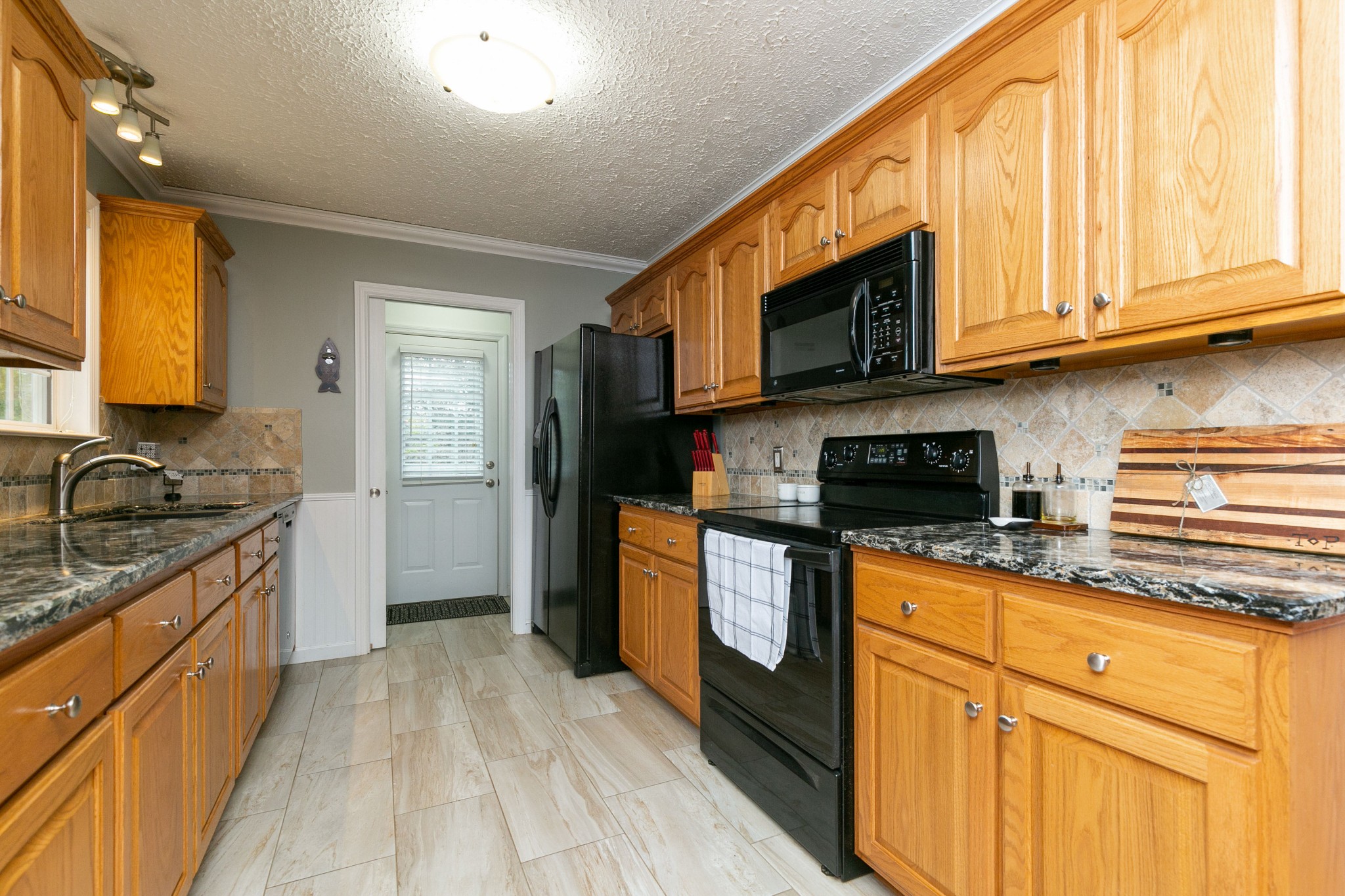 19 B Vantrease Road Brush Creek, TN 38547 - Photo 11 of 41 a kitchen with stainless steel appliances granite countertop a stove a sink dishwasher and a microwave oven with cabinets