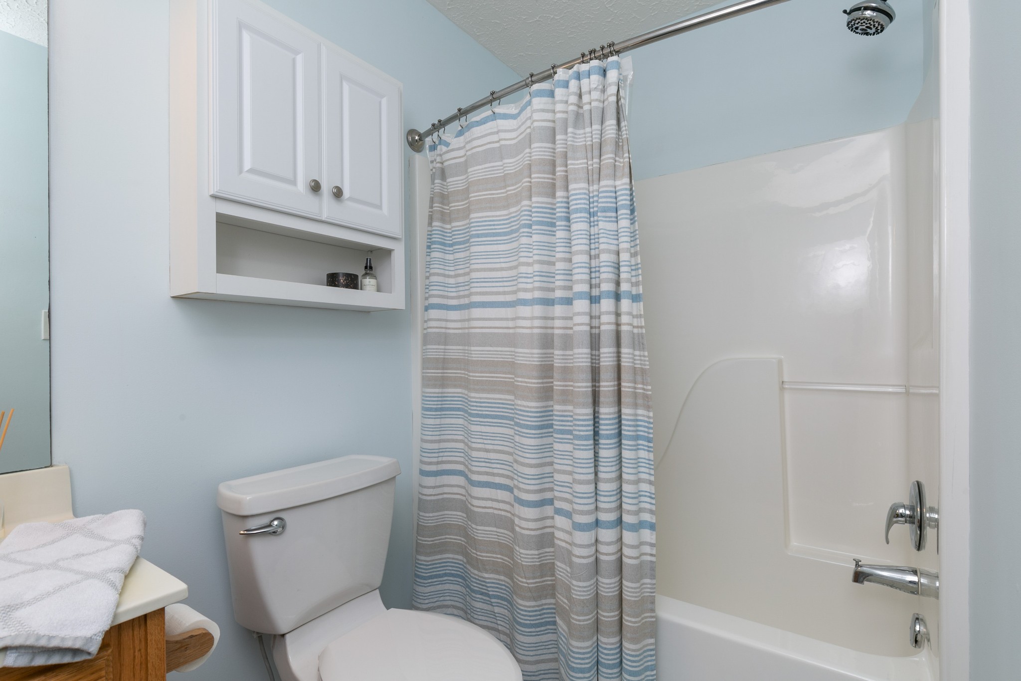 19 B Vantrease Road Brush Creek, TN 38547 - Photo 25 of 41 a bathroom with a toilet and a shower curtain