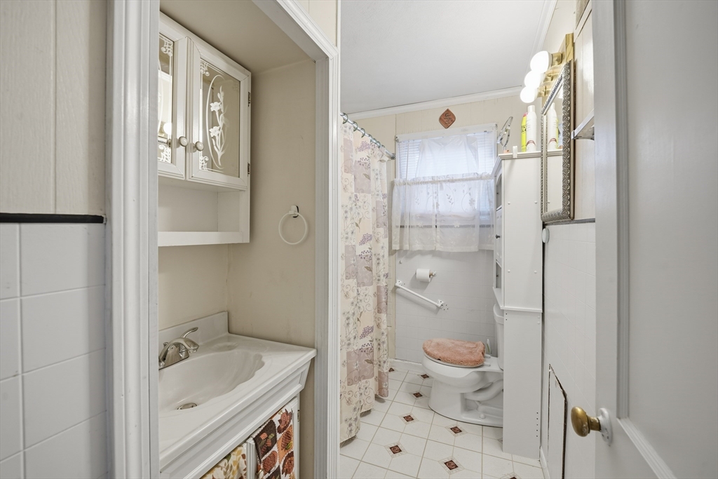 744 Bradley Road Springfield, MA 01109 - Photo 12 of 24 a bathroom with a tub sink and mirror