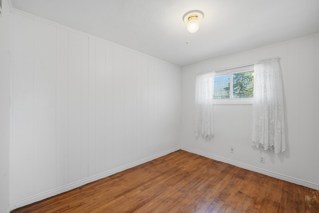 744 Bradley Road Springfield, MA 01109 - Photo 15 of 24 an empty room with wooden floor and window