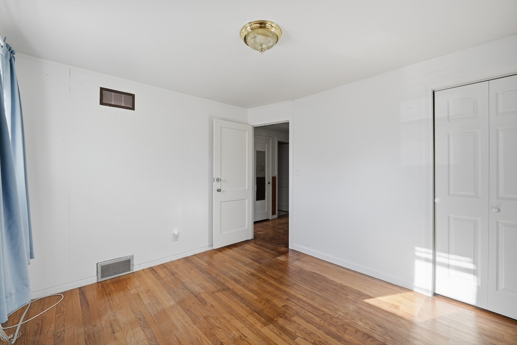 744 Bradley Road Springfield, MA 01109 - Photo 19 of 24 a view of empty room with wooden floor and window