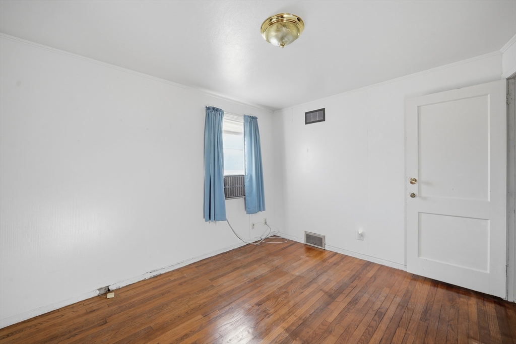 744 Bradley Road Springfield, MA 01109 - Photo 20 of 24 an empty room with wooden floor and window