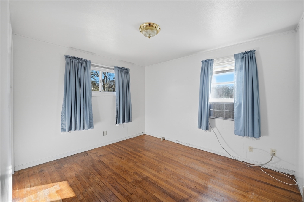 744 Bradley Road Springfield, MA 01109 - Photo 22 of 24 a view of an empty room with wooden floor and a window