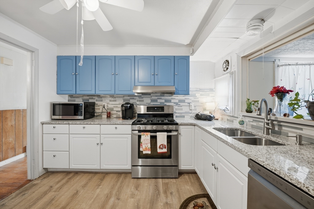 744 Bradley Road Springfield, MA 01109 - Photo 9 of 24 a kitchen with a sink cabinets and stainless steel appliances