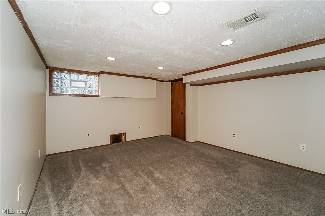 911 Dan Street Akron, OH 44310 - Photo 10 of 20 Carpeted spare room with a textured ceiling