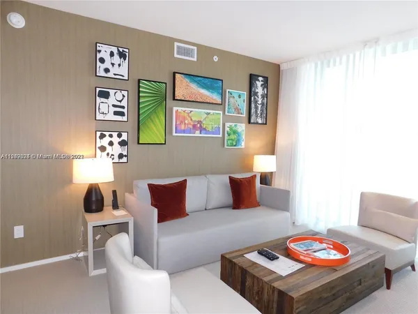 a living room with furniture and wall painting