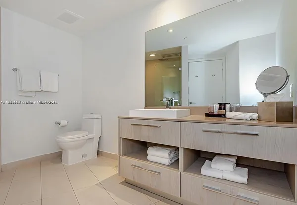 a bedroom with two beds and a painting on the wall