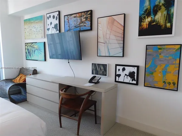 a bed sitting in a bedroom next to a lamp