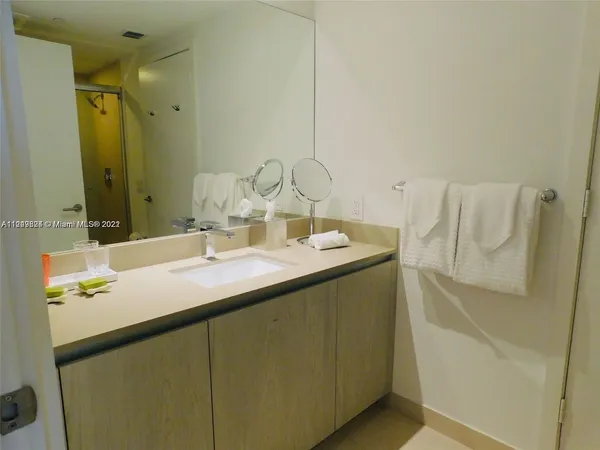 a bathroom with a toilet a sink and a mirror