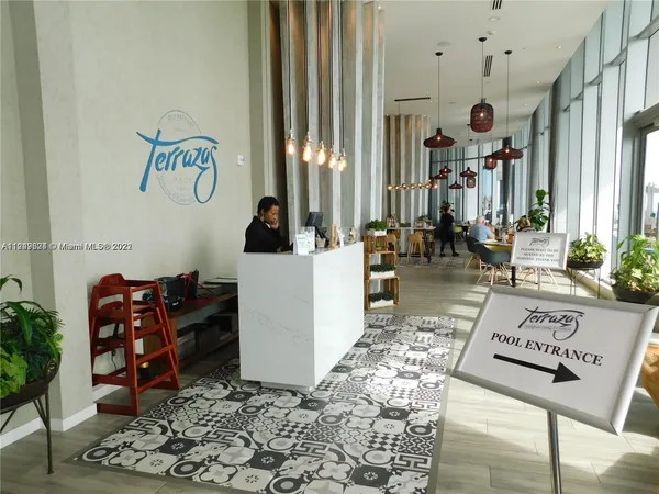 a view of a living room and floor to ceiling window or kitchen