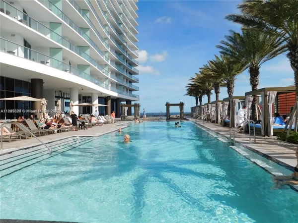 a view of yard with swimming pool and sitting area
