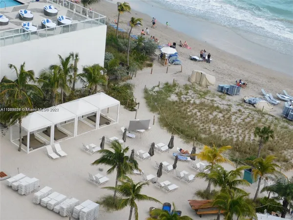 an aerial view of a house with a yard and lake view