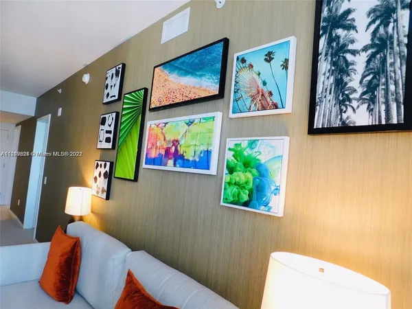 a painting on the wall with a painting on the wall and a potted plant