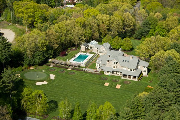 an aerial view of a house with yard swimming pool and outdoor seating