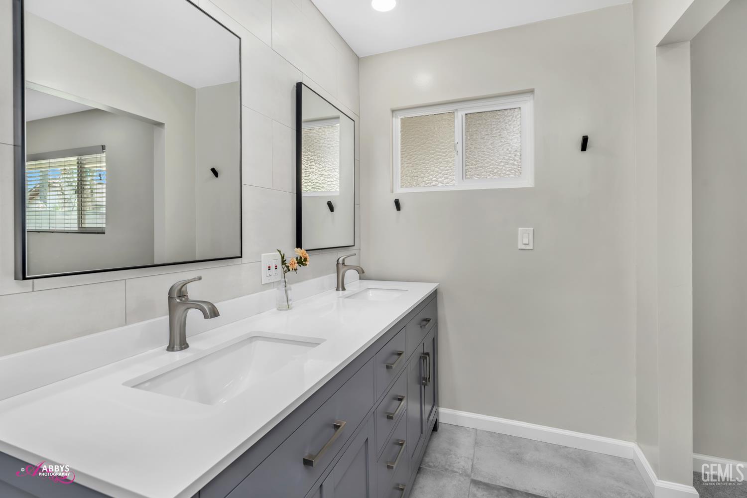 Undisclosed Address Bakersfield, CA 93309 - Photo 17 of 22 a bathroom with a sink and a mirror