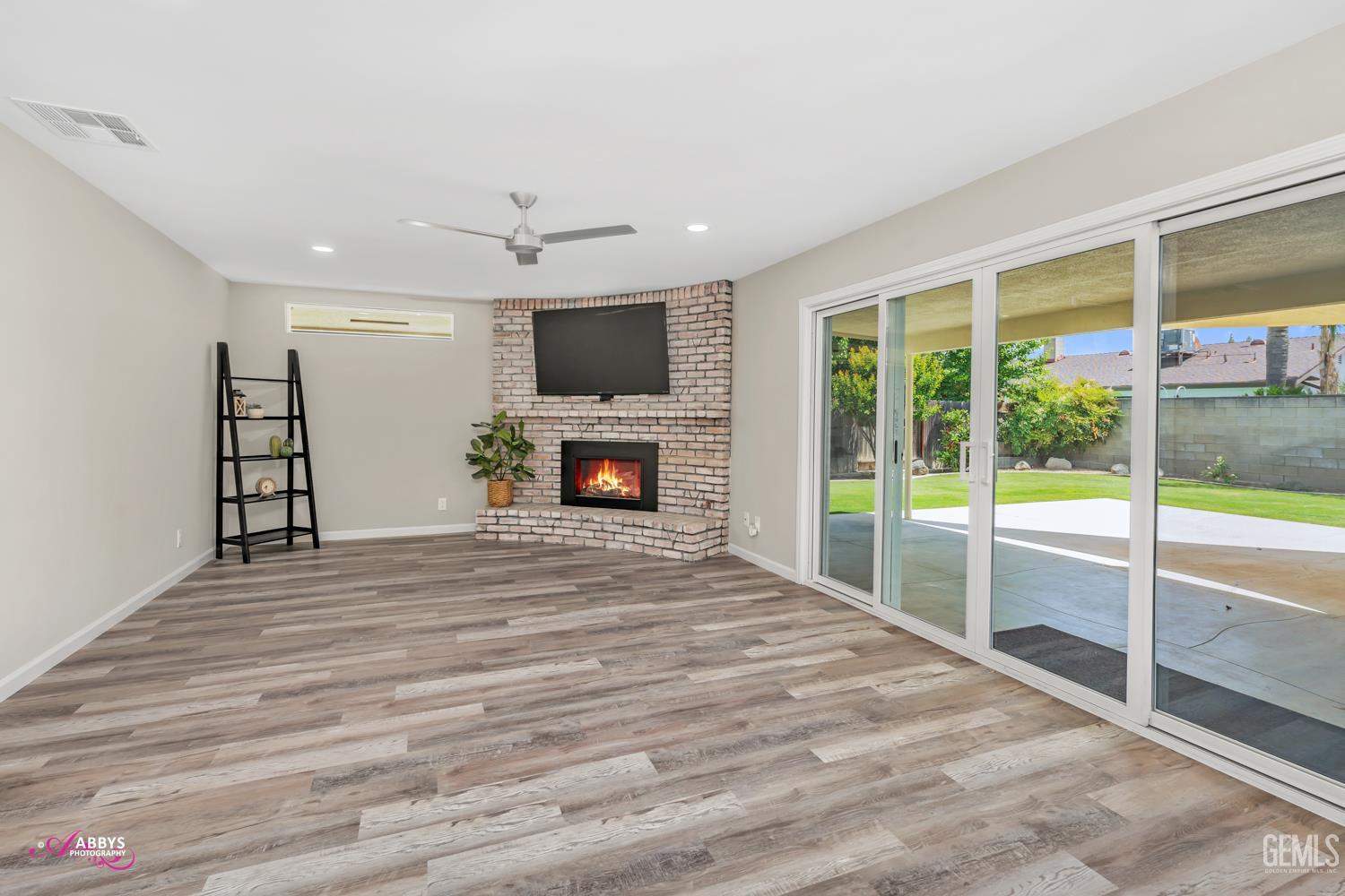 Undisclosed Address Bakersfield, CA 93309 - Photo 4 of 22 a view of livingroom with furniture flat screen tv and floor to ceiling window