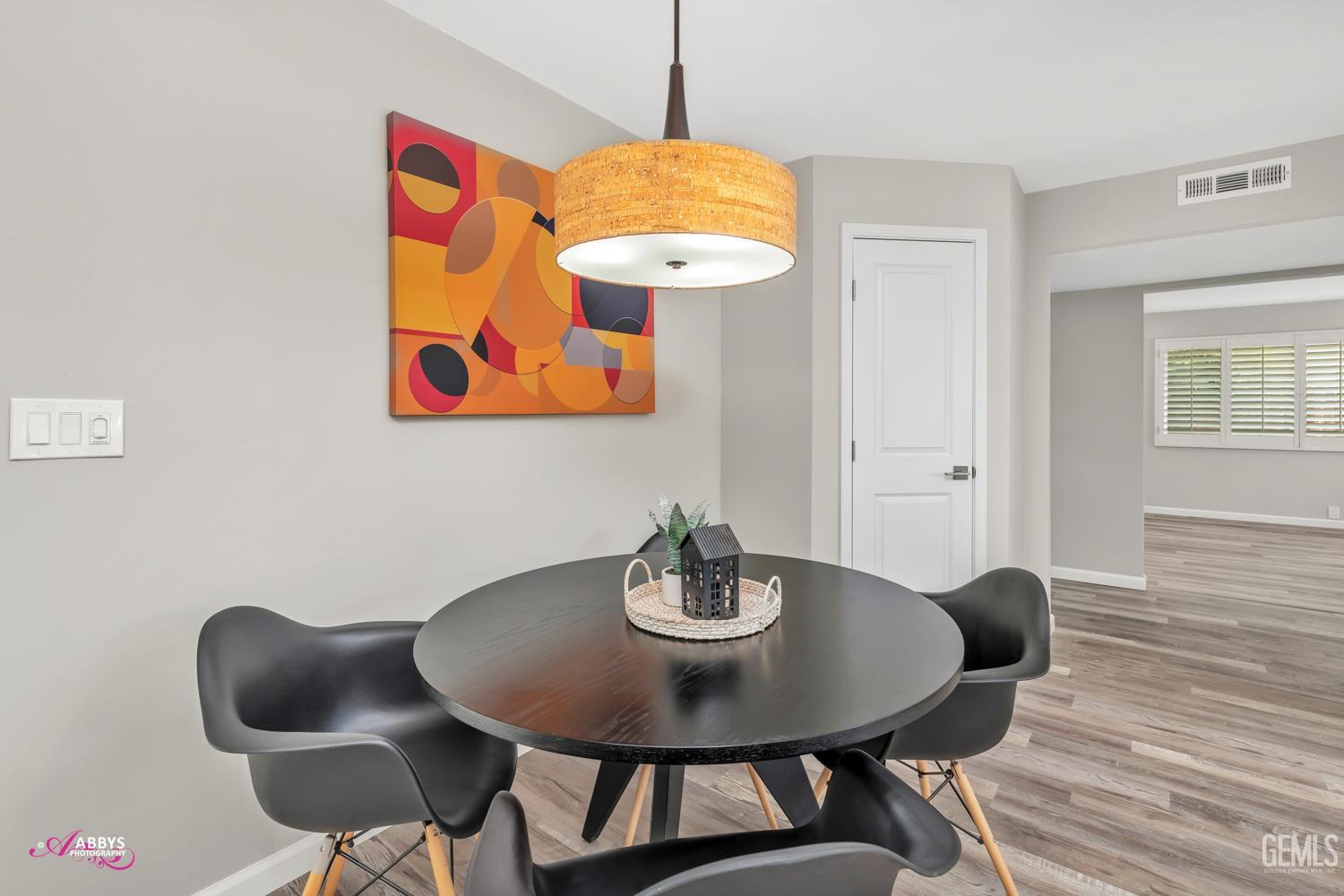 Undisclosed Address Bakersfield, CA 93309 - Photo 6 of 22 a view of a dining room with furniture and wooden floor