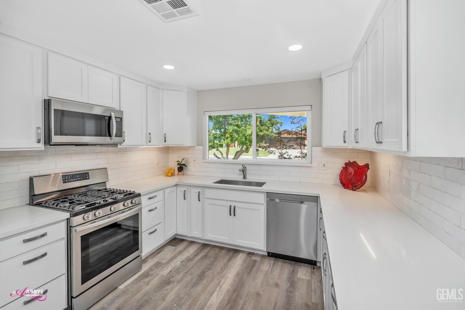 Undisclosed Address Bakersfield, CA 93309 - Photo 8 of 22 a kitchen with granite countertop a sink cabinets stainless steel appliances and window