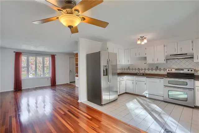 a kitchen with a refrigerator and a stove top oven