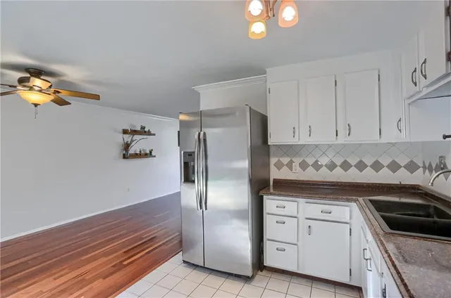a kitchen with cabinets and stainless steel appliances