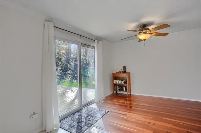 a view of a room with wooden floor and a window