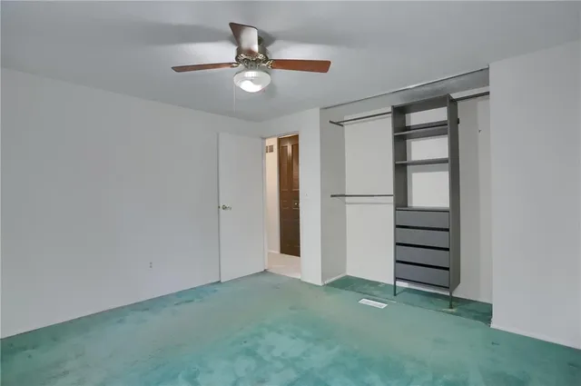 an empty room with closet and entryway