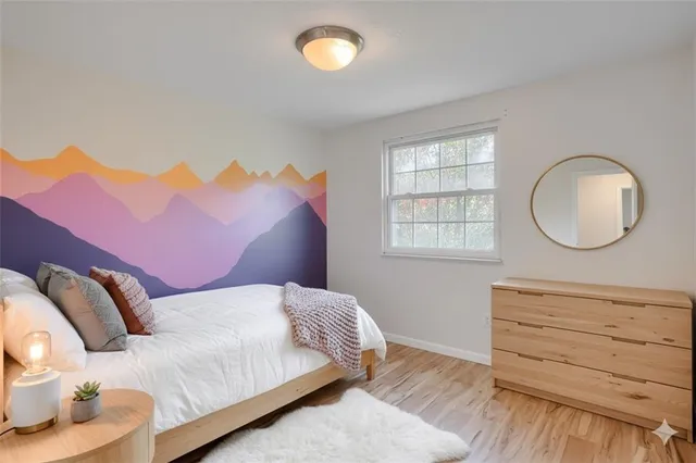 a bedroom with a bed and wooden floor