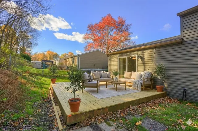 a view of a patio with couches table and chairs and potted plants
