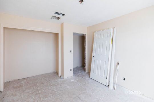 1653 South Fire Opal Street Ridgecrest, CA 93555 - Photo 18 of 28 an empty room with a ceiling fan