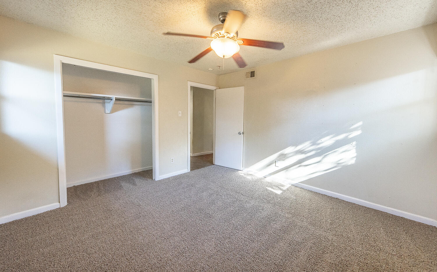 5017 46th Street Lubbock, TX 79414 - Photo 12 of 24 a view of a big room with windows and chandelier fan