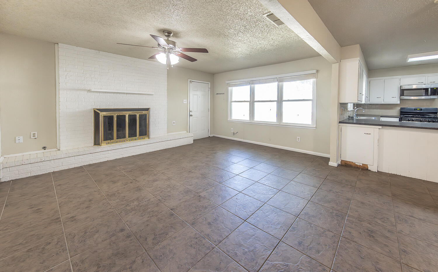 5017 46th Street Lubbock, TX 79414 - Photo 2 of 24 a view of an empty room with a kitchen