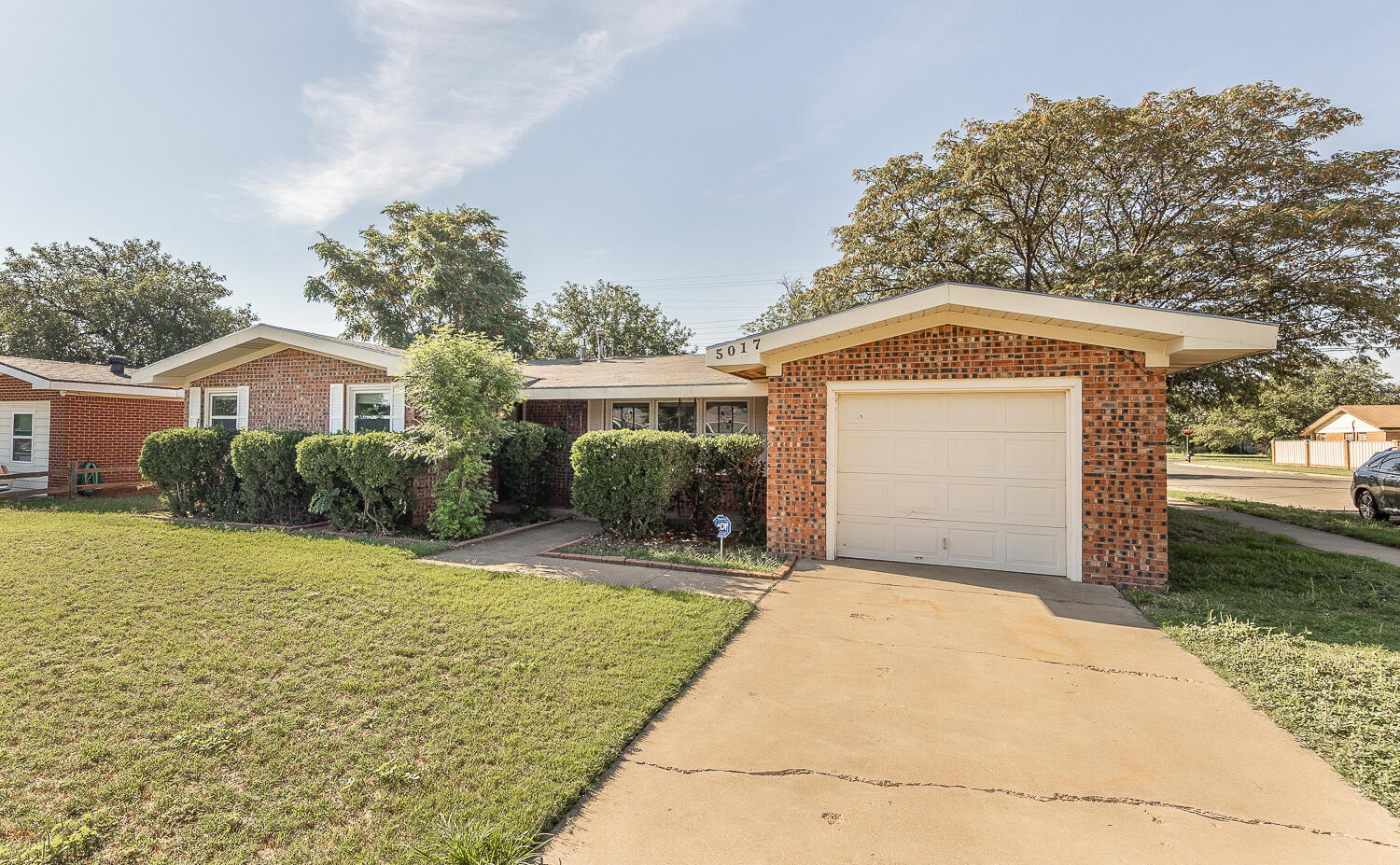 5017 46th Street Lubbock, TX 79414 - Photo 24 of 24 a front view of a house with a yard and garage
