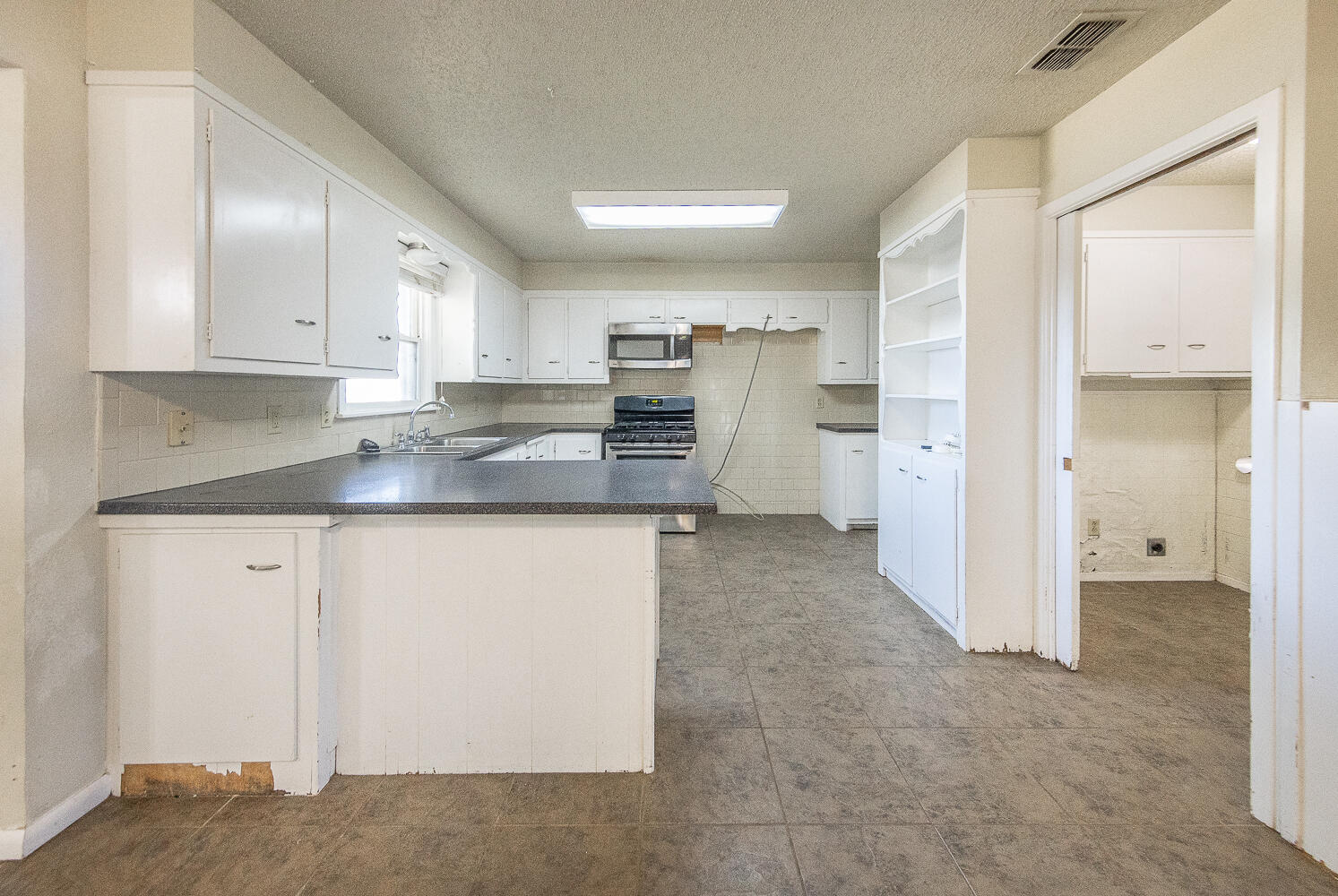 5017 46th Street Lubbock, TX 79414 - Photo 3 of 24 a kitchen with stainless steel appliances granite countertop a refrigerator and a stove
