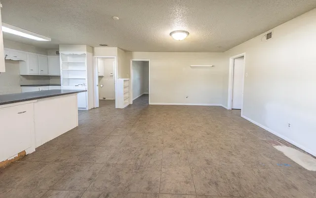 a view of a kitchen with a sink and cabinets