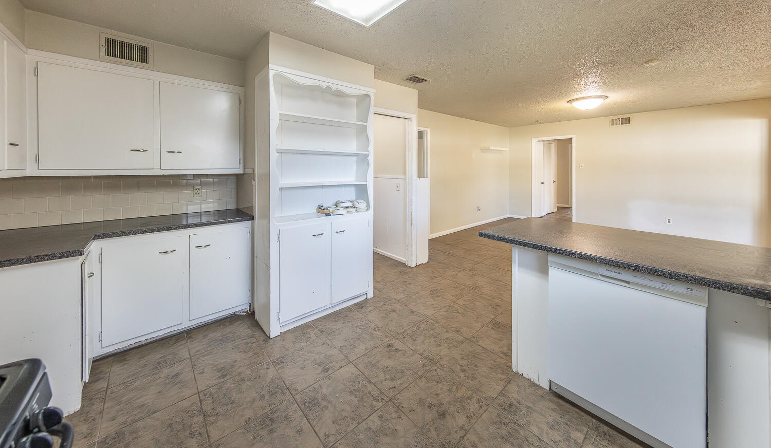 5017 46th Street Lubbock, TX 79414 - Photo 7 of 24 a kitchen with granite countertop white cabinets and a sink
