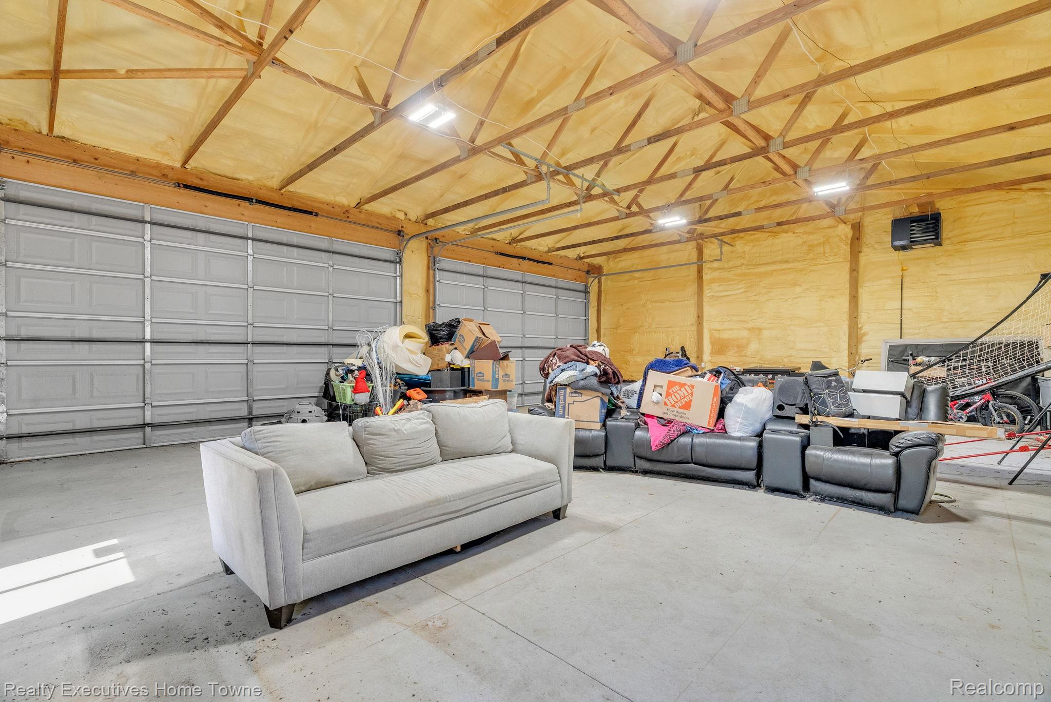 6560 Roach Road Lexington, MI 48450 - Photo 32 of 36 Spacious interior with exposed wooden truss ceiling and concrete flooring
