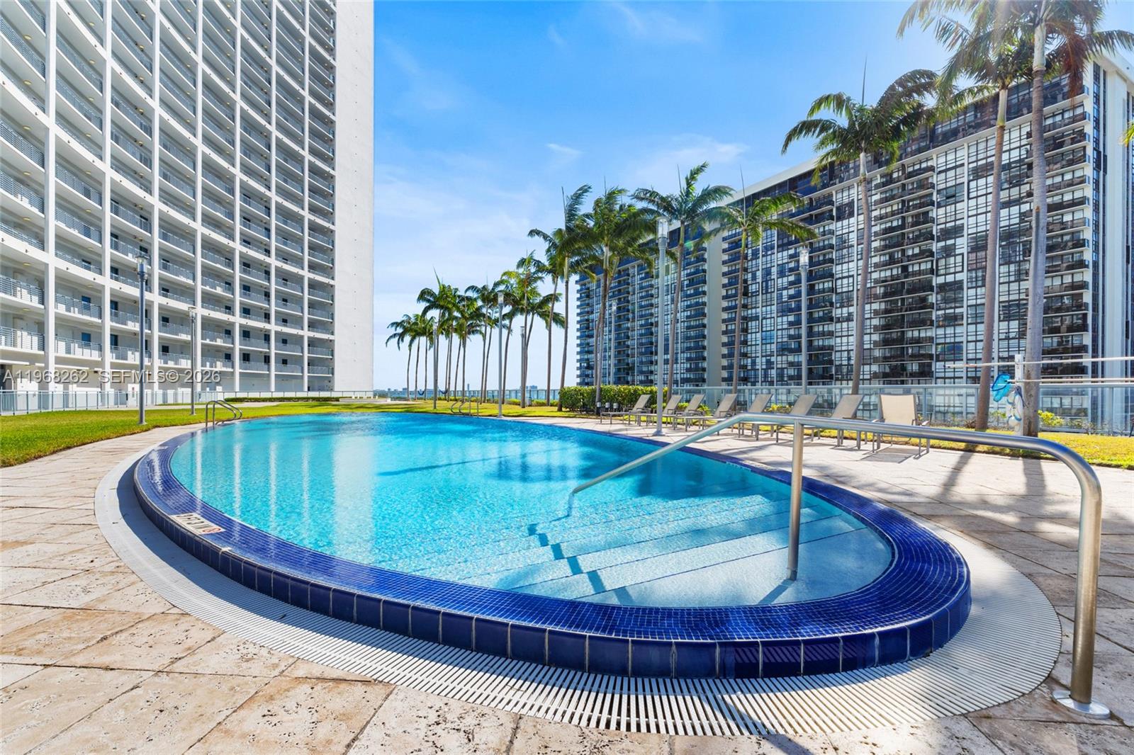 601 Northeast 36th Street, Unit 3407 Miami, FL 33137 - Photo 32 of 41 a view of a swimming pool with a lounge chair
