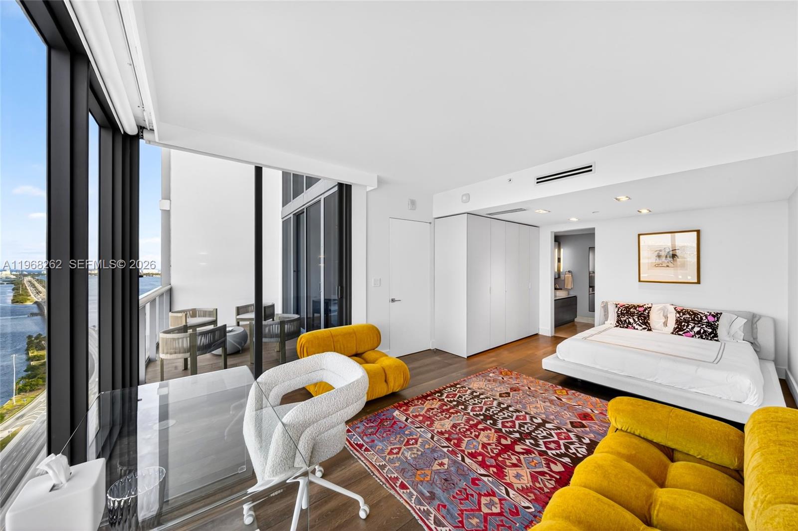 601 Northeast 36th Street, Unit 3407 Miami, FL 33137 - Photo 8 of 41 a bedroom with a bed and wooden floor