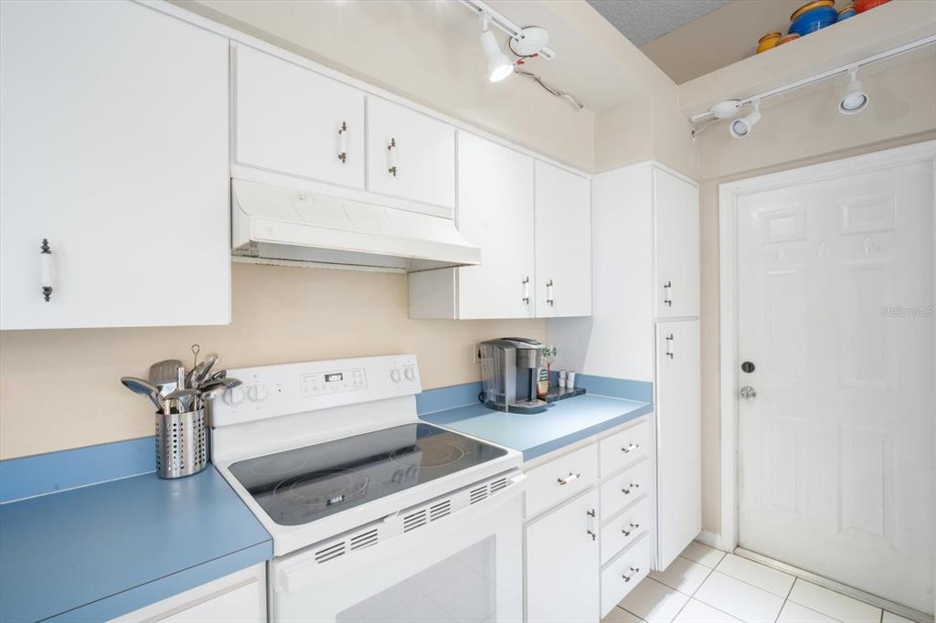 7282 Aloe Drive Spring Hill, FL 34607 - Photo 11 of 25 a kitchen with white cabinets and white appliances