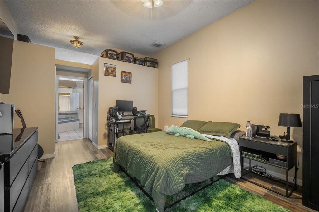 7282 Aloe Drive Spring Hill, FL 34607 - Photo 13 of 25 a bed room with a bed and a television