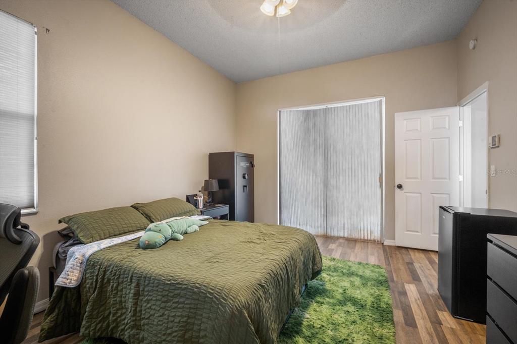 7282 Aloe Drive Spring Hill, FL 34607 - Photo 14 of 25 a bedroom with a bed and a tv