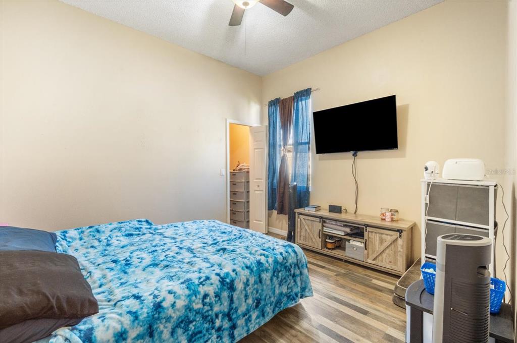 7282 Aloe Drive Spring Hill, FL 34607 - Photo 16 of 25 a bedroom with a bed and a flat screen tv