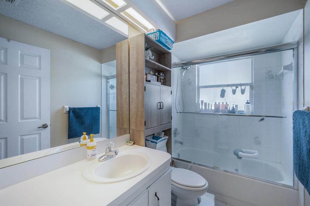 7282 Aloe Drive Spring Hill, FL 34607 - Photo 18 of 25 a bathroom with a sink toilet and shower